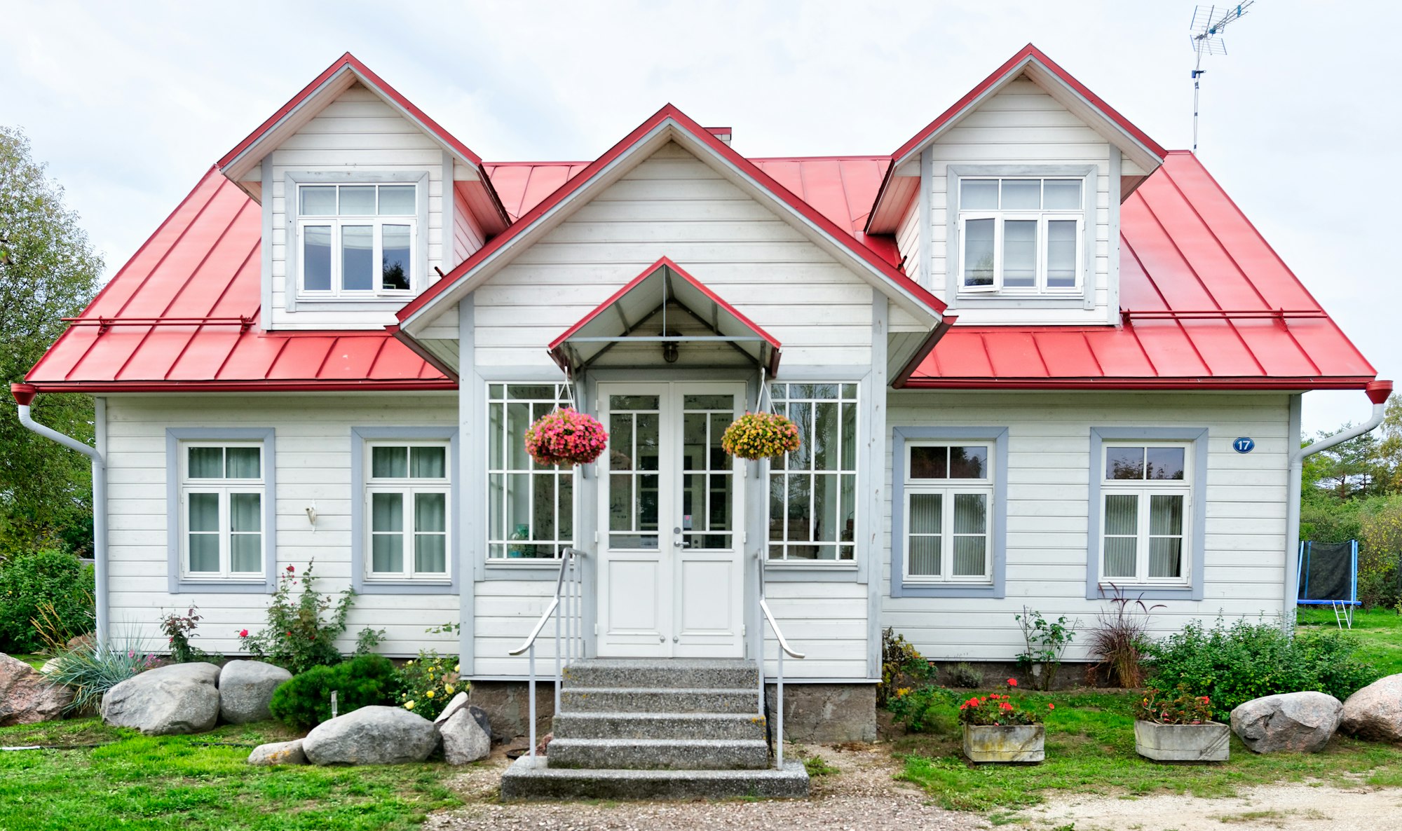 Welcoming covered front porch and entry of a white home